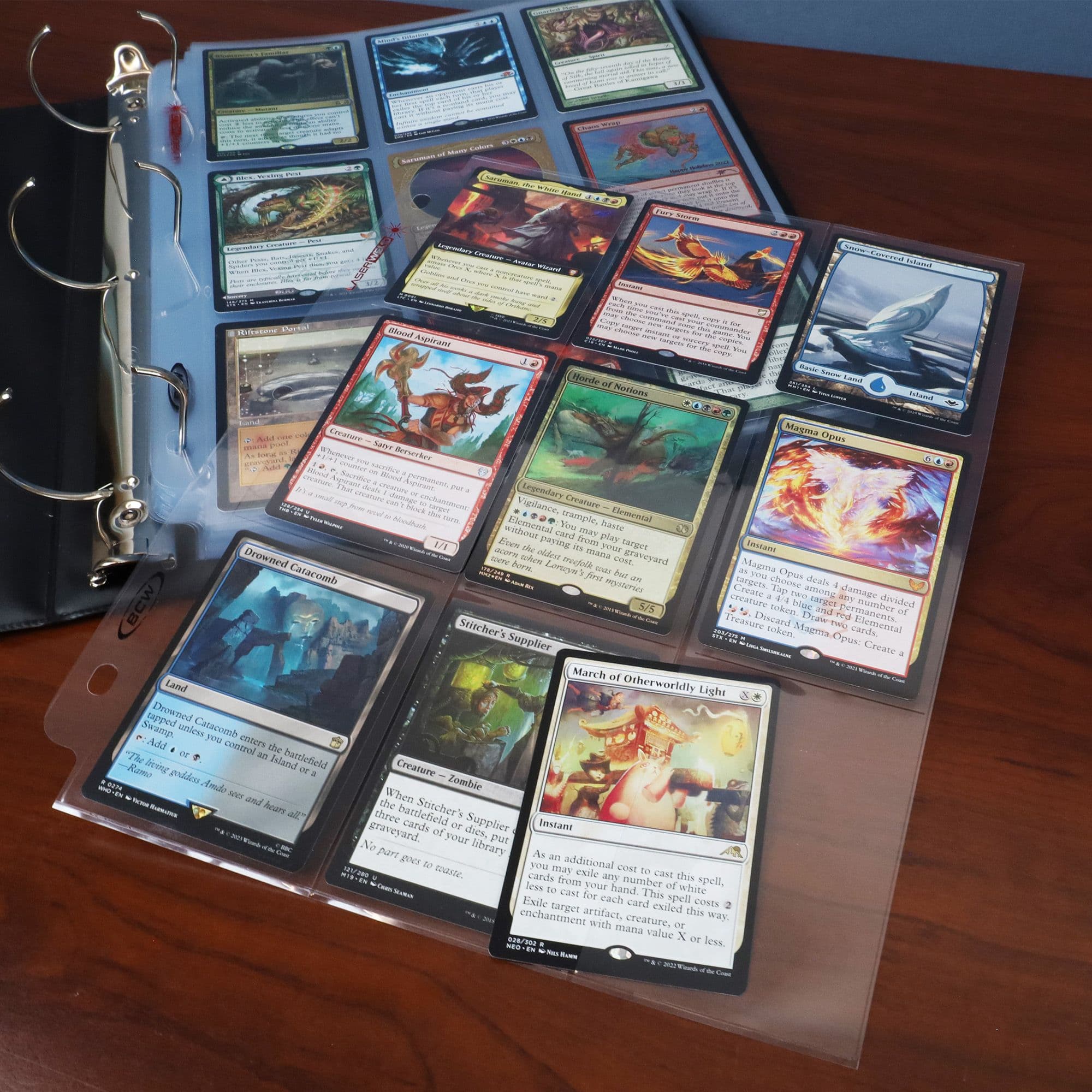 LaserWeld Pages - 9 Pocket - Side Load - 100ct Pack table setting with tcg gaming cards
