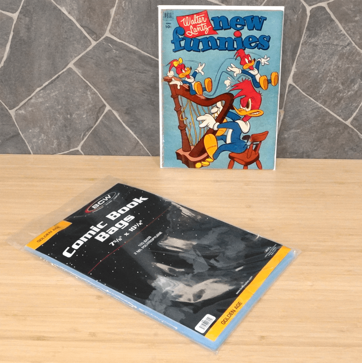 Package of BCW Golden Age Comic Book Bags next to a displayed comic in a bag