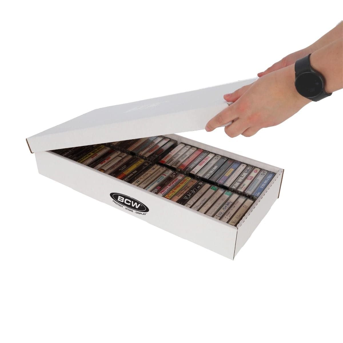 BCW Cassette Tape Storage Box angled with hand removing lid to reveal a full box of organized cassette tapes.