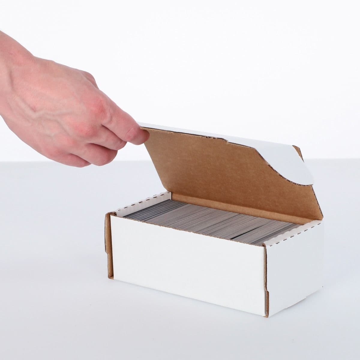 BCW 400 Count Storage Box, hand lifting the lid to reveal contents of the box.