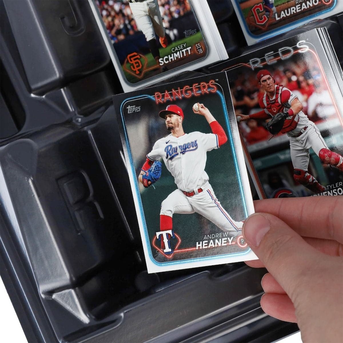 BCW Safesort Card Tray, close up of hand placing a sports card into the tray, showcasing the indentation of the tray, to prevent damage to your cards while sorting