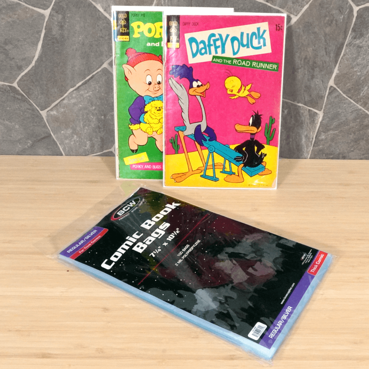 Package of BCW Silver Age Thick Comic Book Bags with Daffy Duck and Porky Pig comic books bagged and boarded