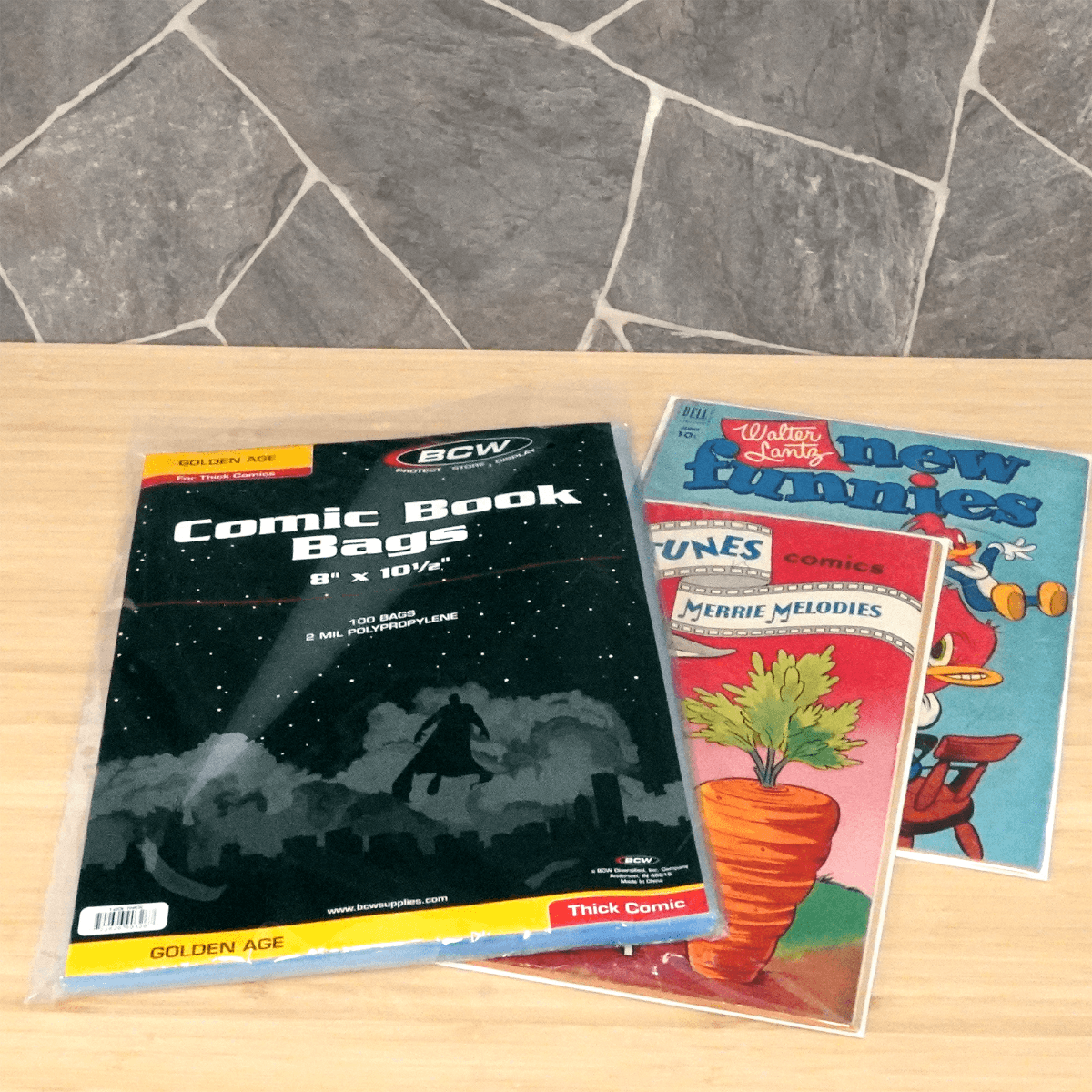 Package of BCW Golden Age Thick Comic Book Bags with two golden age comic books