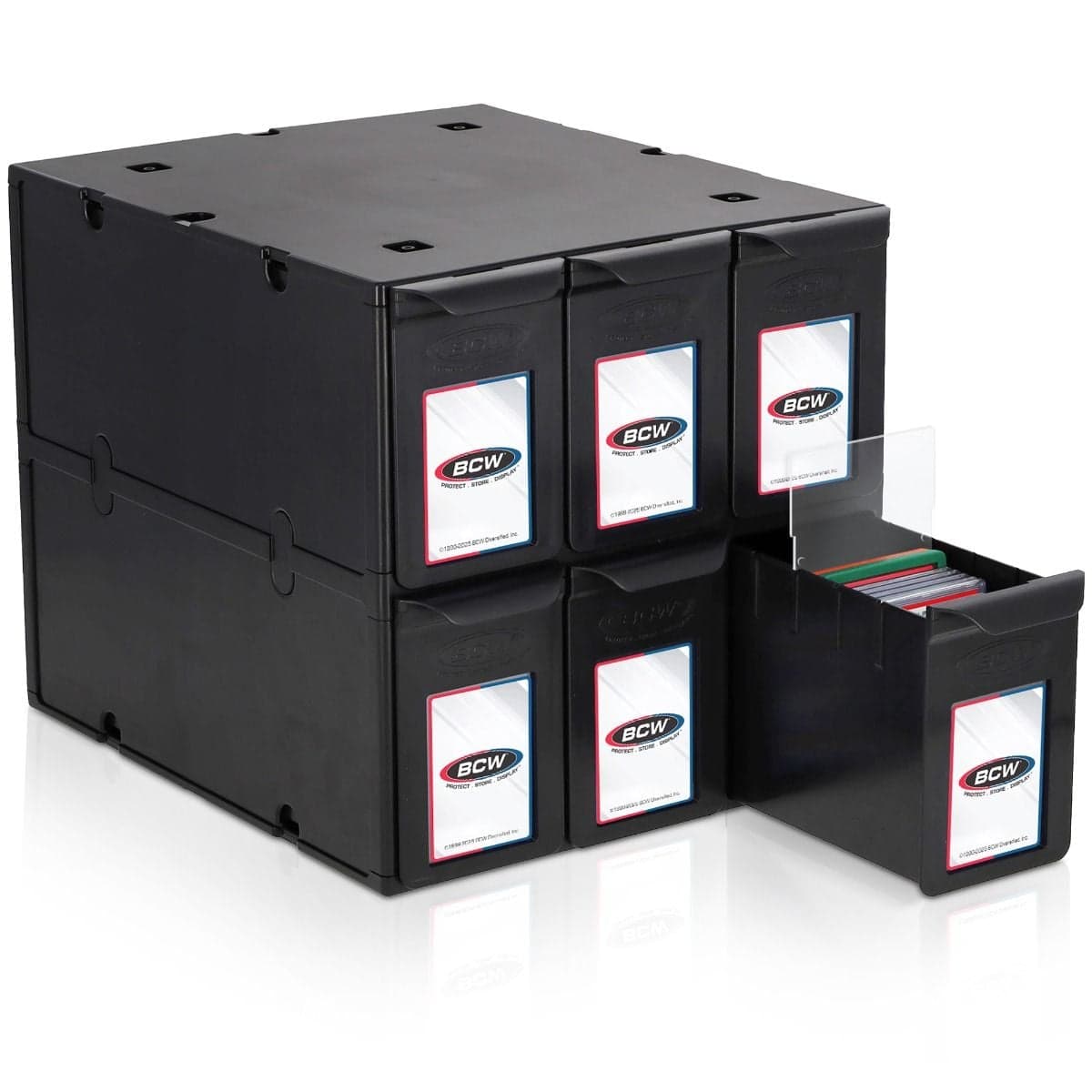 Black modular storage system featuring six BCW plastic drawers arranged in two stacked rows of three. Each drawer includes a front label holder, with one drawer partially pulled out to reveal organized graded trading cards inside.