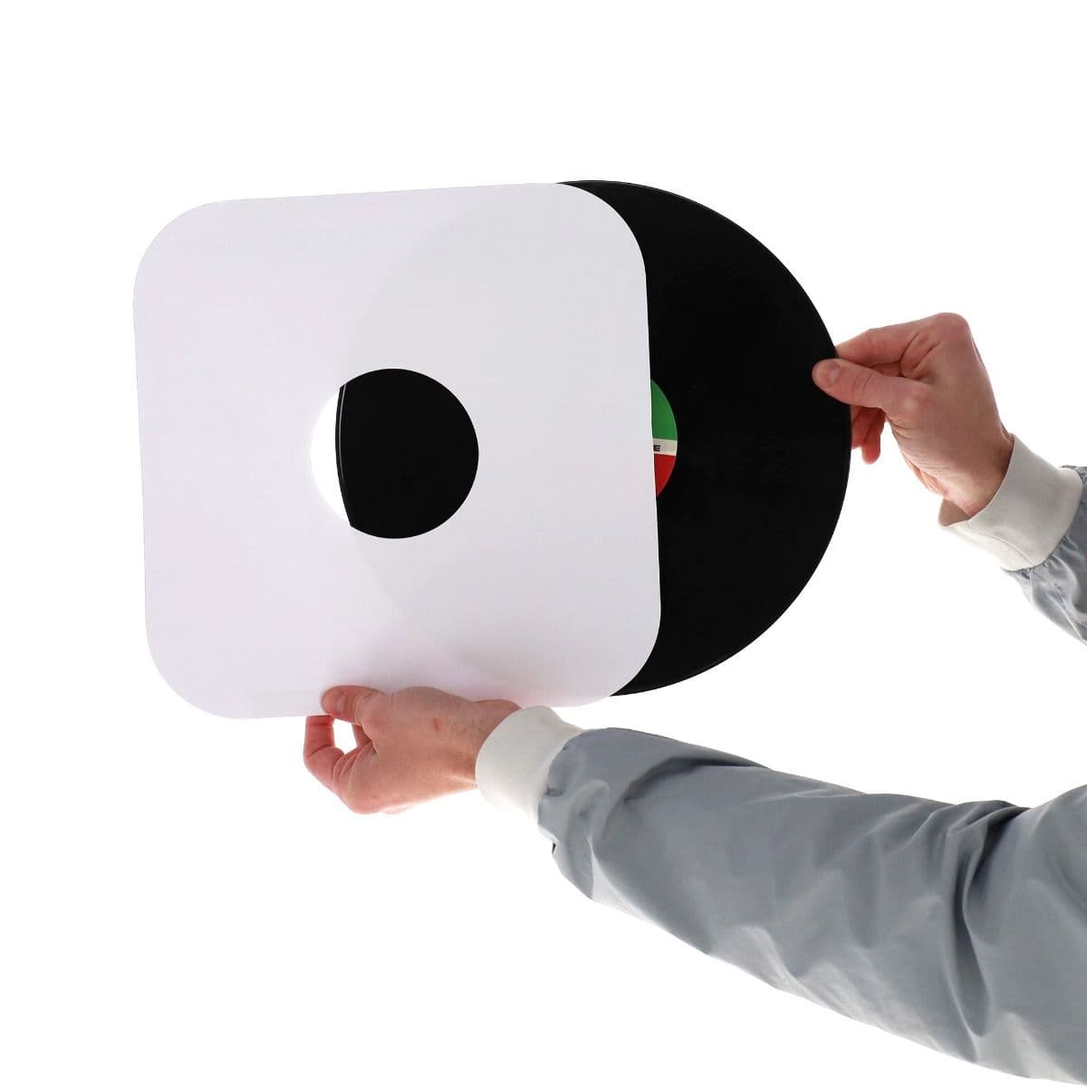 BCW 12 Inch Record Paper Inner Sleeves - Round Corners - With Hole - White, hand holding and inserting a record into the inner sleeve
