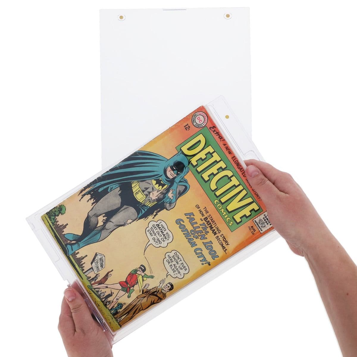 Hand placing a comic into a BCW Magnetic Comic Book Holder - Silver