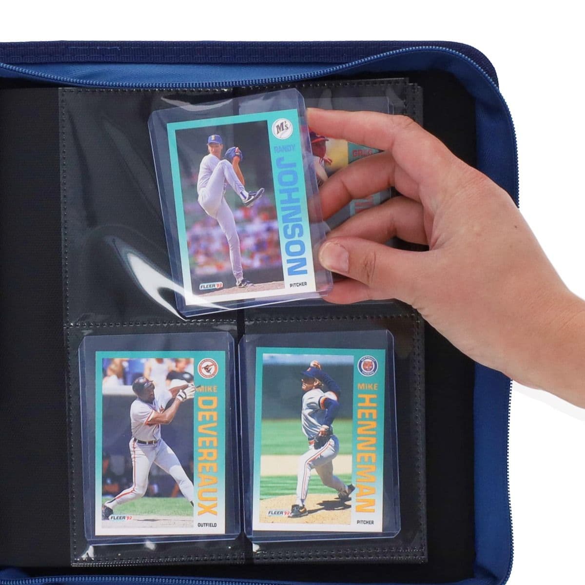 BCW Z-Folio 4-Pocket LX Album - Toploaders - Blue hand inserting toploaded card into page