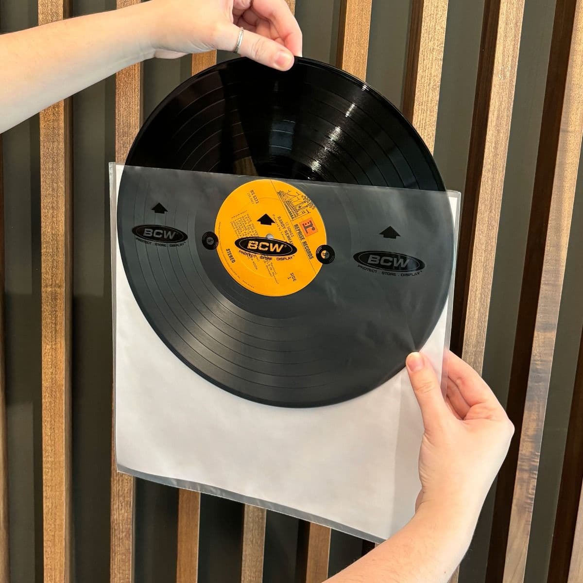 BCW 12-Inch Record Audiophile Inner Sleeves, hand holding and inserting a record into the inner sleeve