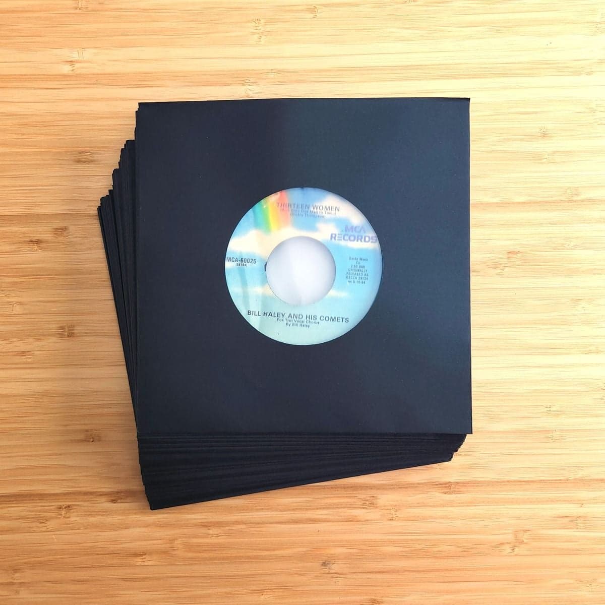 Overhead image of a stack of BCW 7 Inch Record Paper Inner Sleeves - Polylined - With Hole - Black