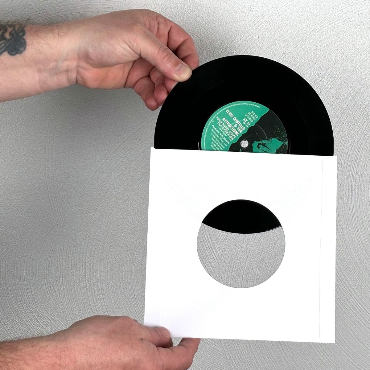 7 Inch Record Paper Inner Sleeves - Square Corners - With Hole - White inserting record into sleeve