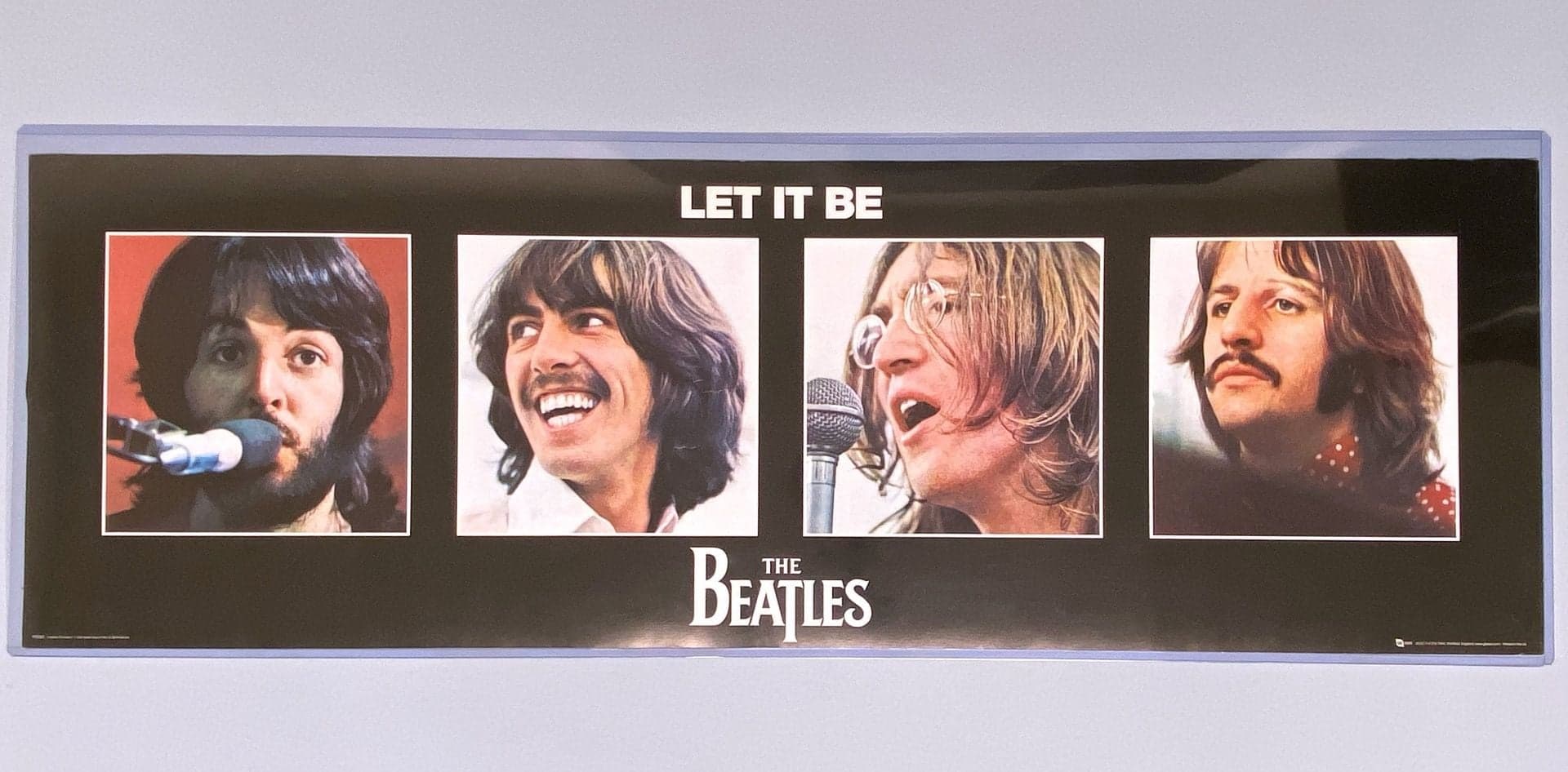 1 BCW 12 by 36 Toploader with a 12 by 36 poster of The Beatles placed inside the holder