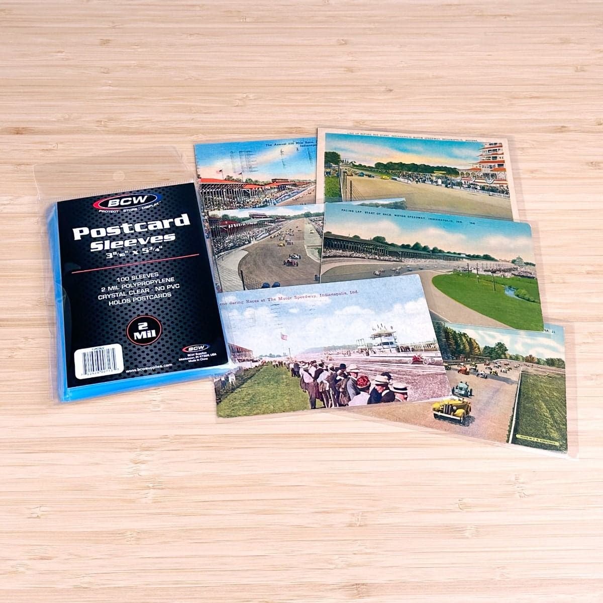 BCW Postcard Sleeve behind package of BCW Postcard Sleeves. Post cards in sleeves group