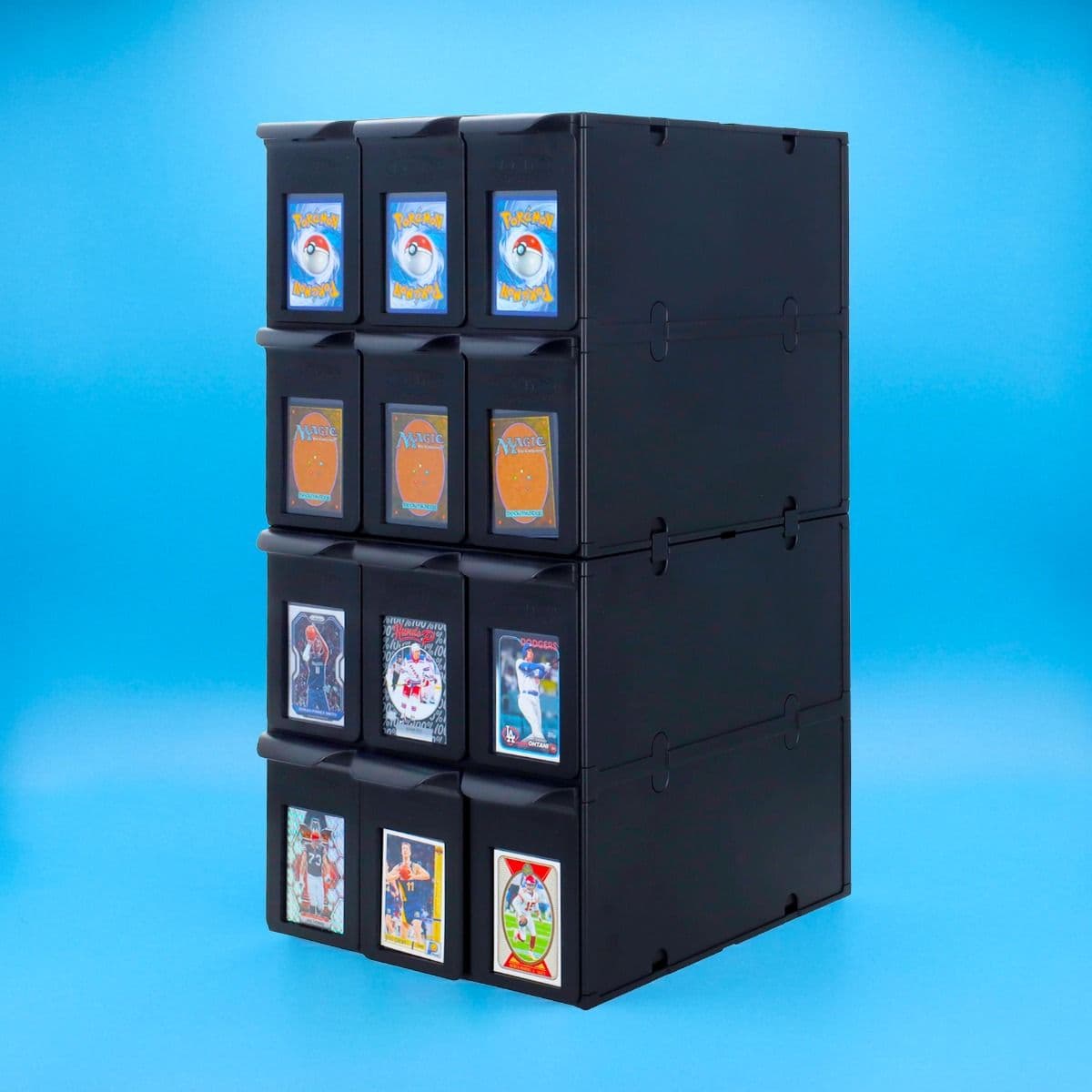 Stacked black modular drawer storage system with multiple compartments displaying trading cards on the front, shown against a blue background.
