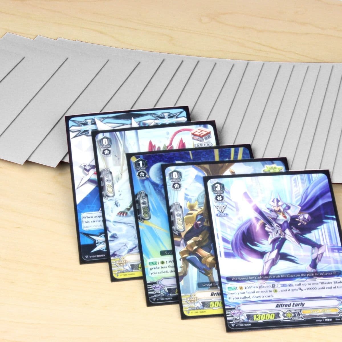 Five cards inside small BCW deck guards displayed in front of a spread of several small BCW gloss deck guards in white.