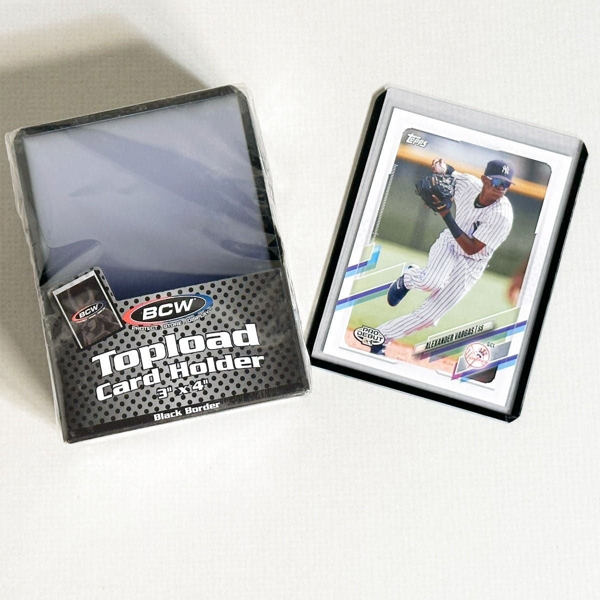 Pack of BCW Topload Card Holders 3x4 with black border. Group picture with baseball card in holder