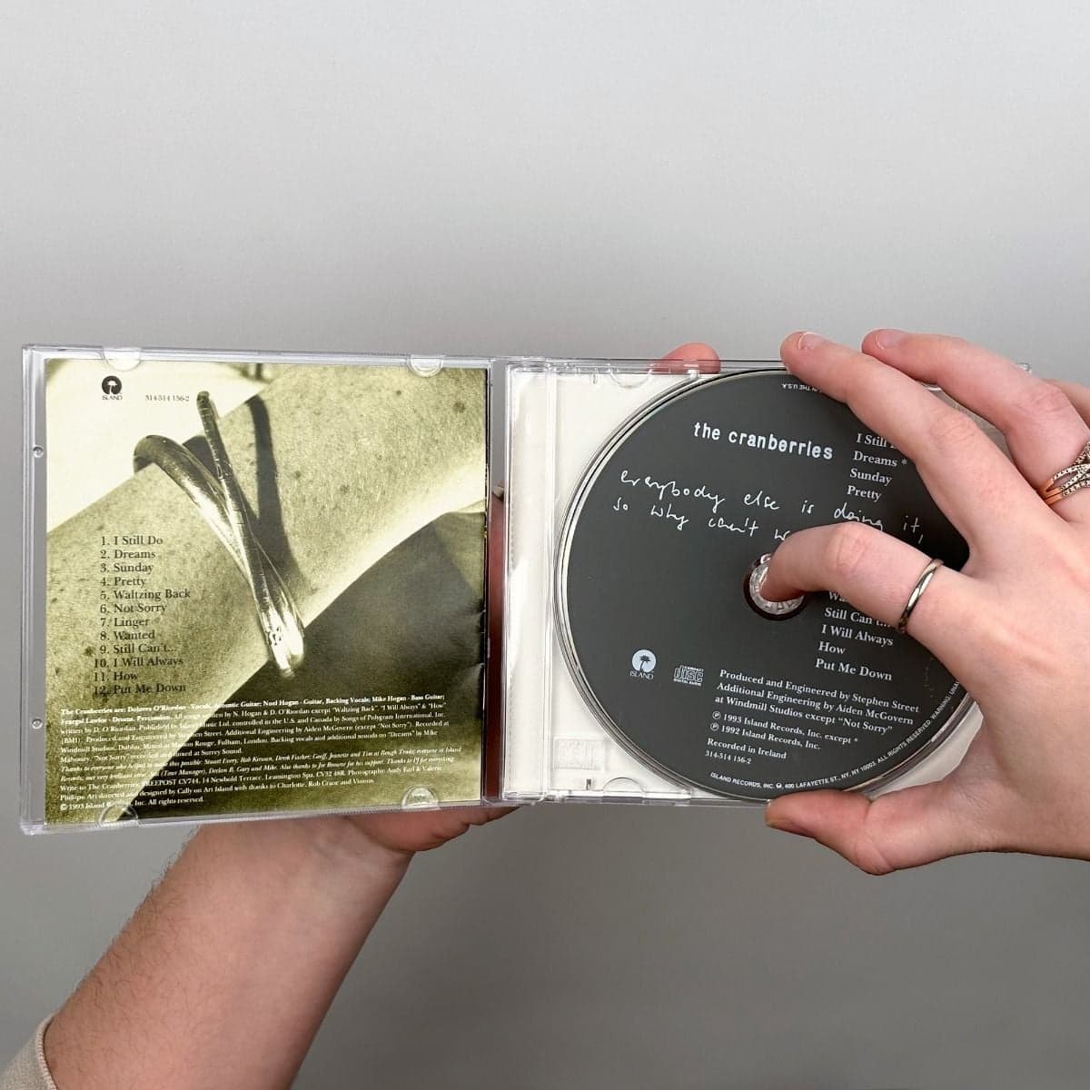 BCW CD Jewel Case, hand taking cd out of jewel case