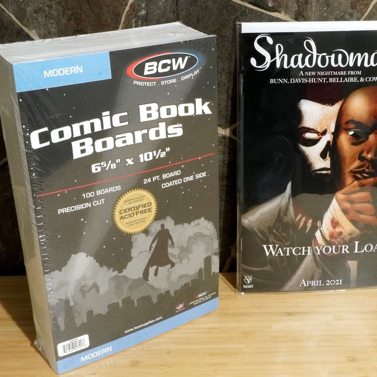 Package of BCW Modern Comic Book Boards grouped with comic book