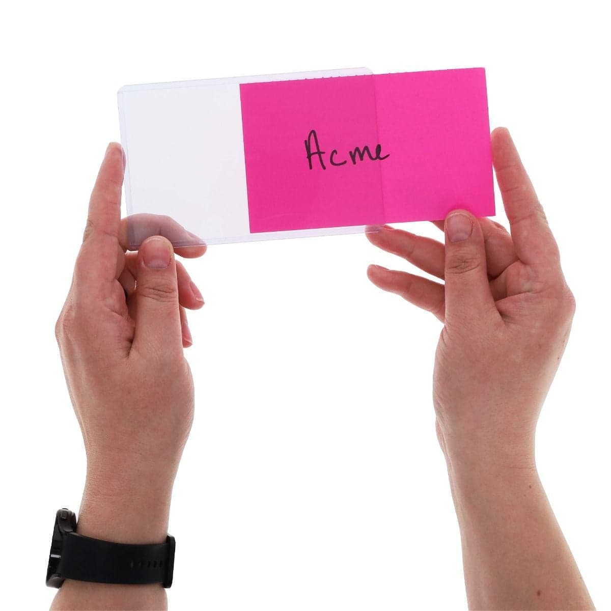 Hands hold a clear BCW 3" x 5" rigid PVC toploader while inserting a bright pink 3" x 5" index card through the open short side, demonstrating the secure fit and easy loading design.