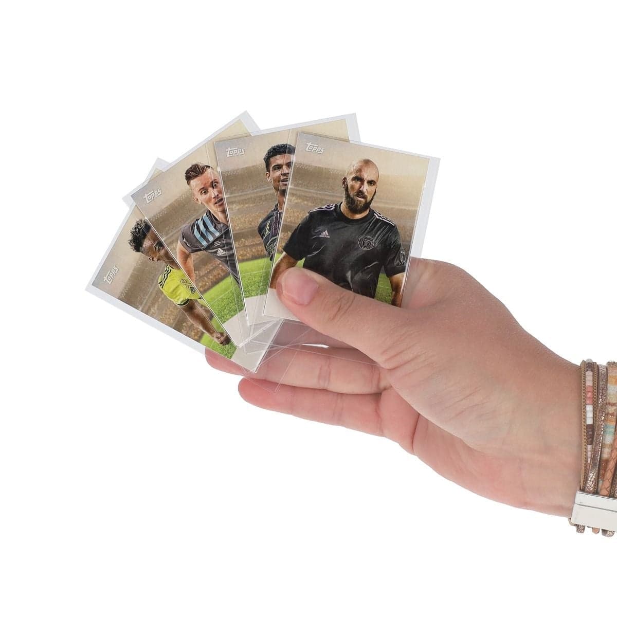 Hands holding BCW 48 Bowman Insert Sleeves with cards inside