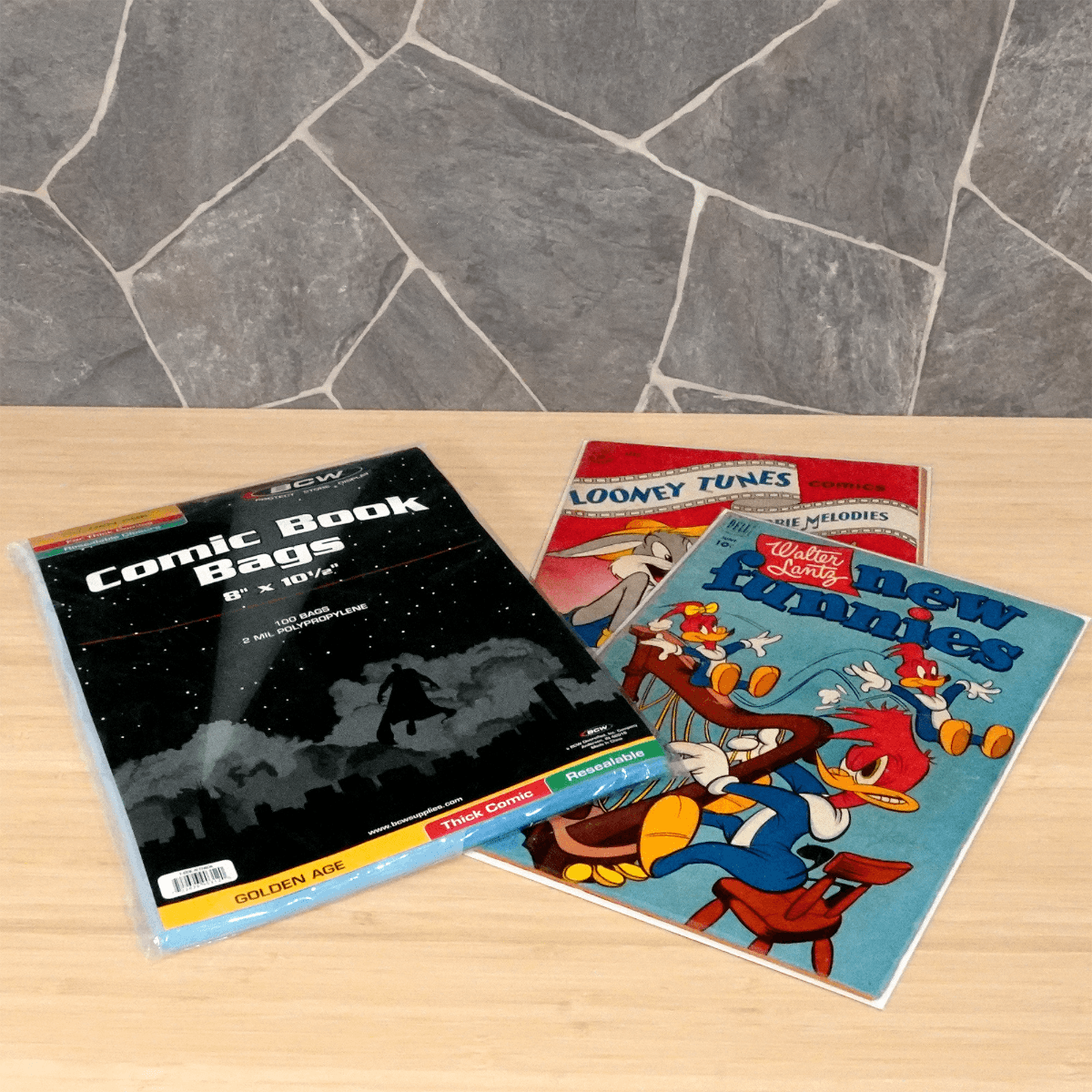 Package of BCW Resealable Golden Age Thick Comic Book Bags with two golden age comic books
