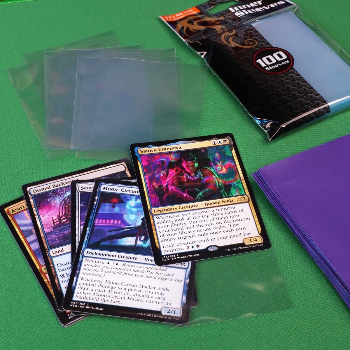 BCW Regular Inner Sleeves, displayed on a table, showcasing someone using the inner sleeves to double sleeve their magic deck.
