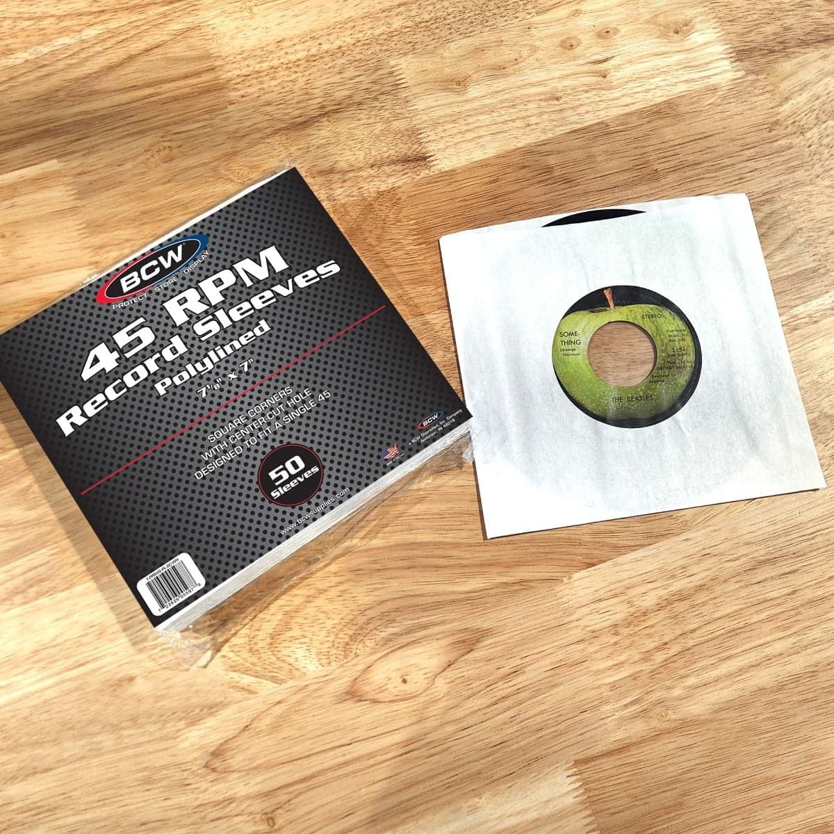 Package of BCW Paper Record Sleeves 45 RPM - Polylined - SQ Corners - With Hole next to record in sleeve