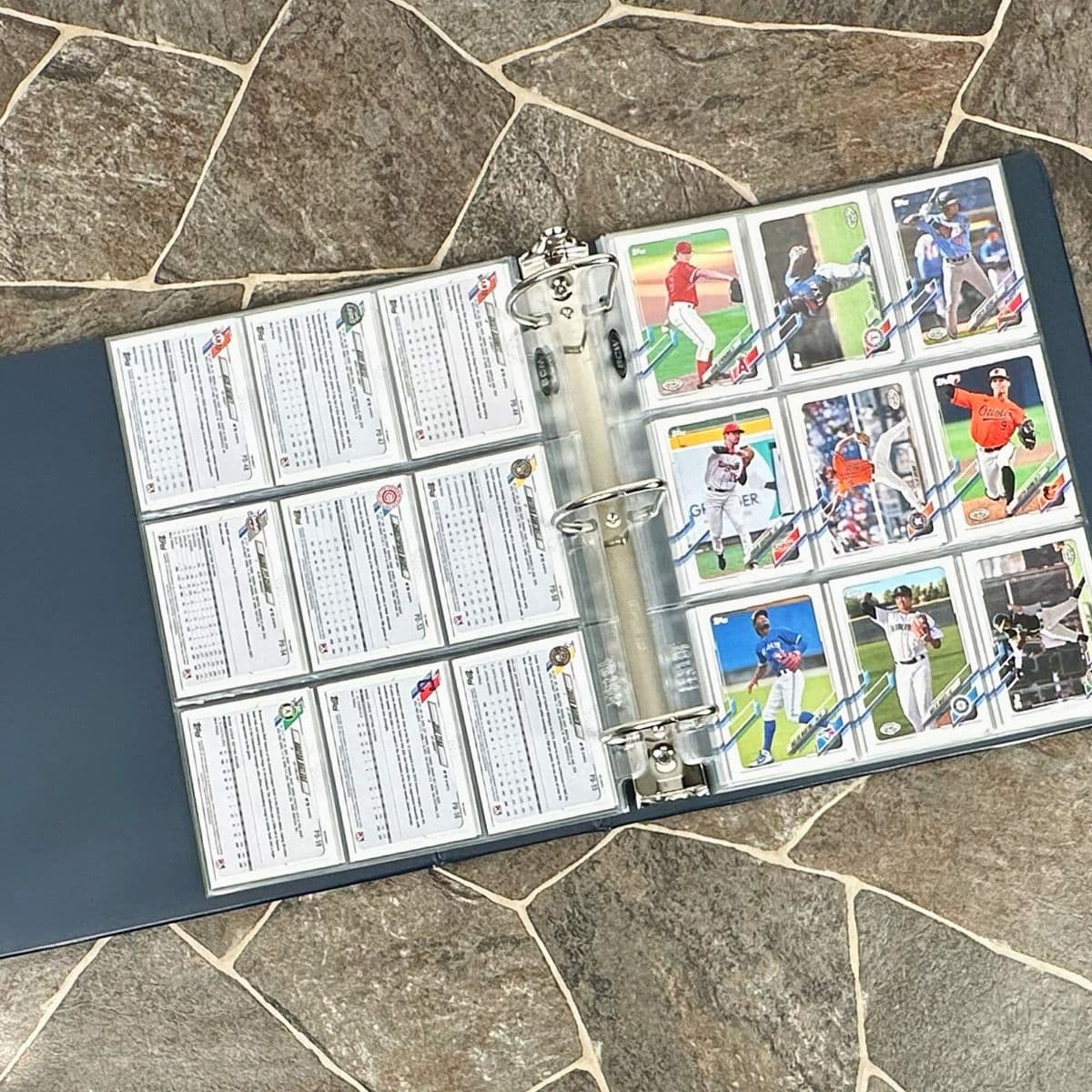 BCW blue baseball card album with baseball cards and BCW pages