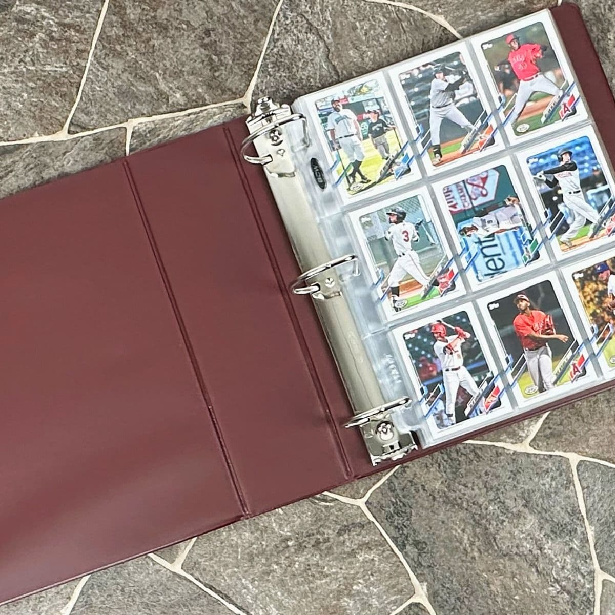 BCW burgundy baseball card album with baseball cards in BCW pages