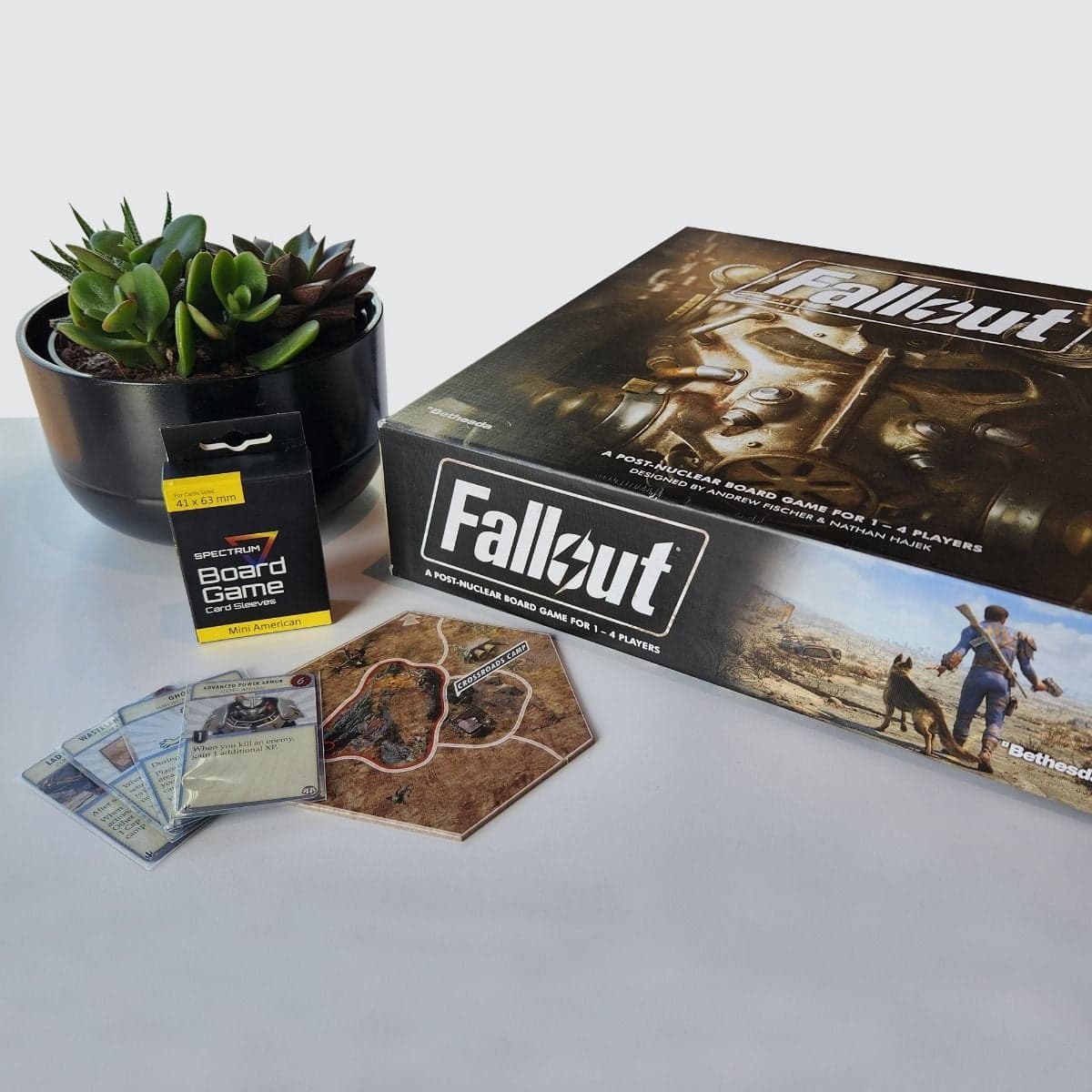 Package of Spectrum Board Game Sleeves - Mini American (41MM x 63MM) on table with Fallout Board game