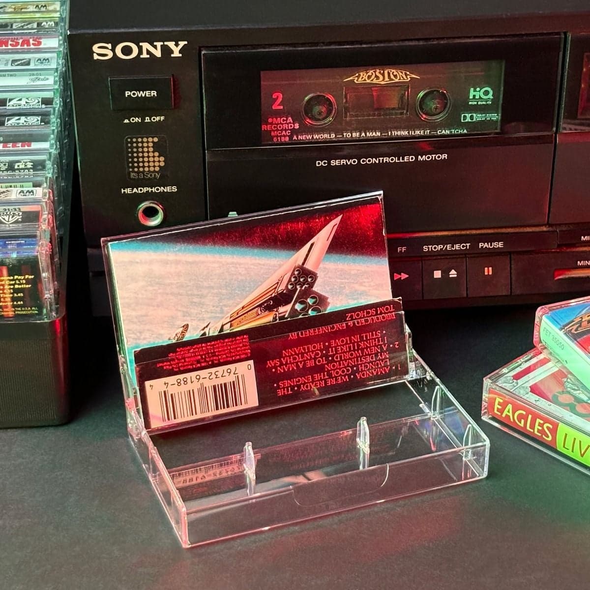 BCW Cassette Cases, opened and displayed infront of a Sony cassette player, with cassette inside being played.