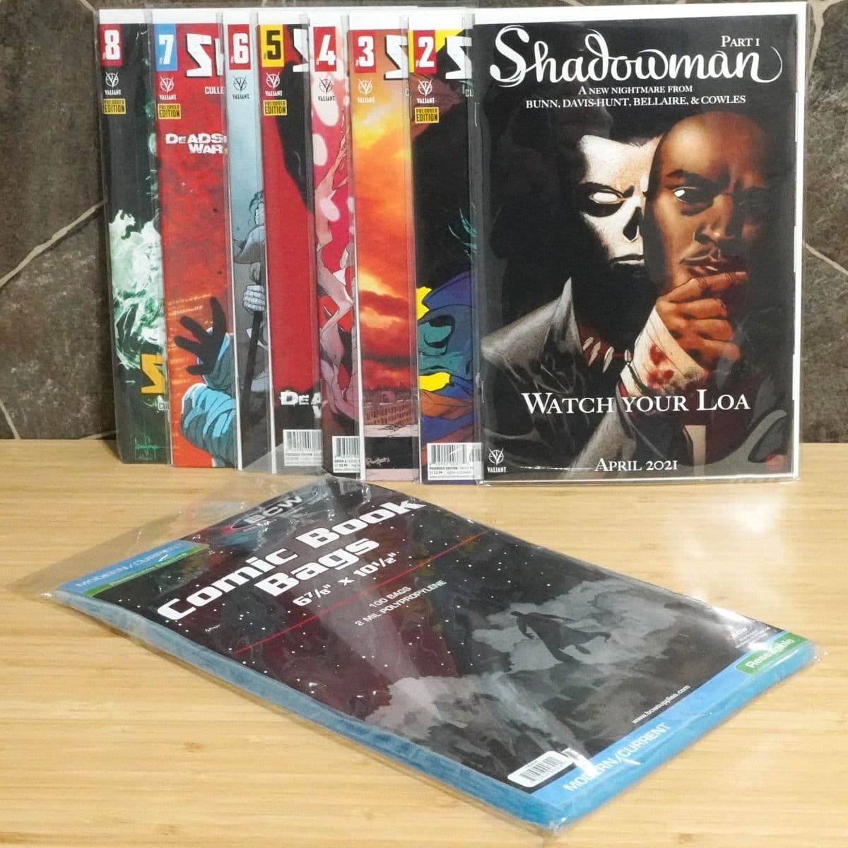 BCW Resealable Comic Book Bags. Current, Modern. 100 bags next to a display of comics in bags
