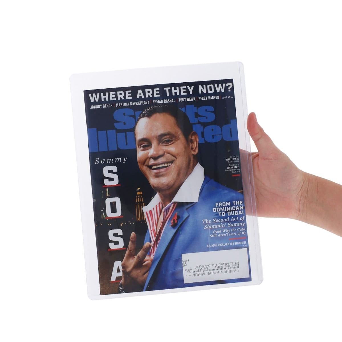 Hand holding a Sports Illustrated magazine protected inside a clear BCW rigid magazine top loader for secure storage and display.
