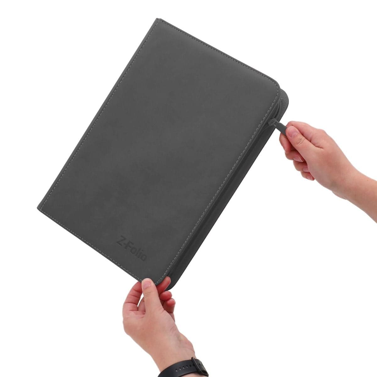 BCW Z-Folio 9-Pocket Album - Gray, hand holding the binder and unzipping it to reveal it's contents.