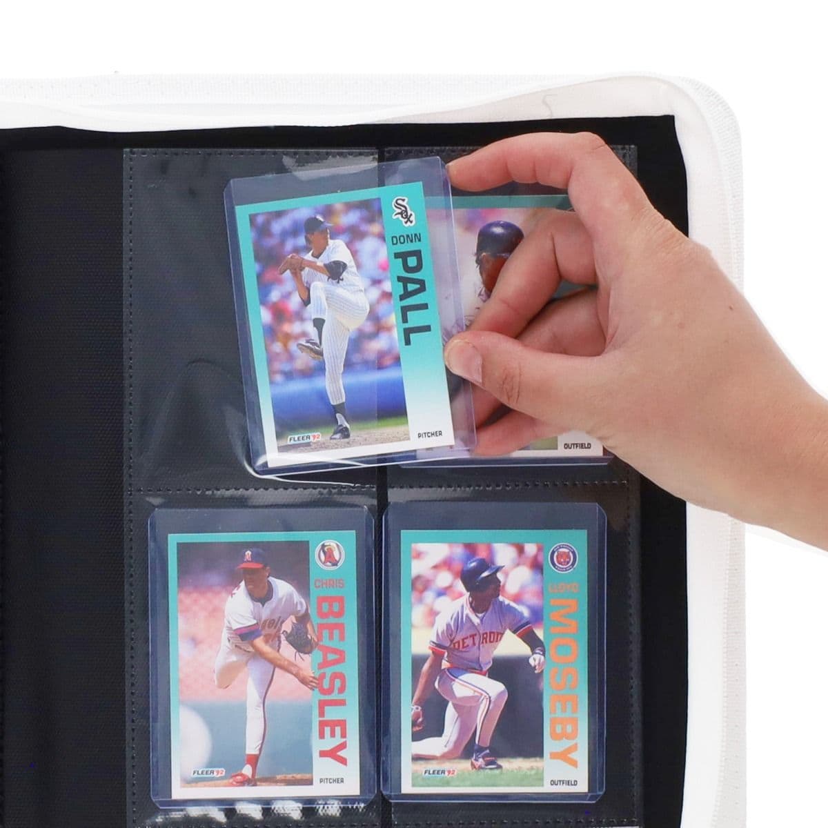 BCW Z-Folio 4-Pocket LX Album - Toploaders - White hand inserting toploaded card into page